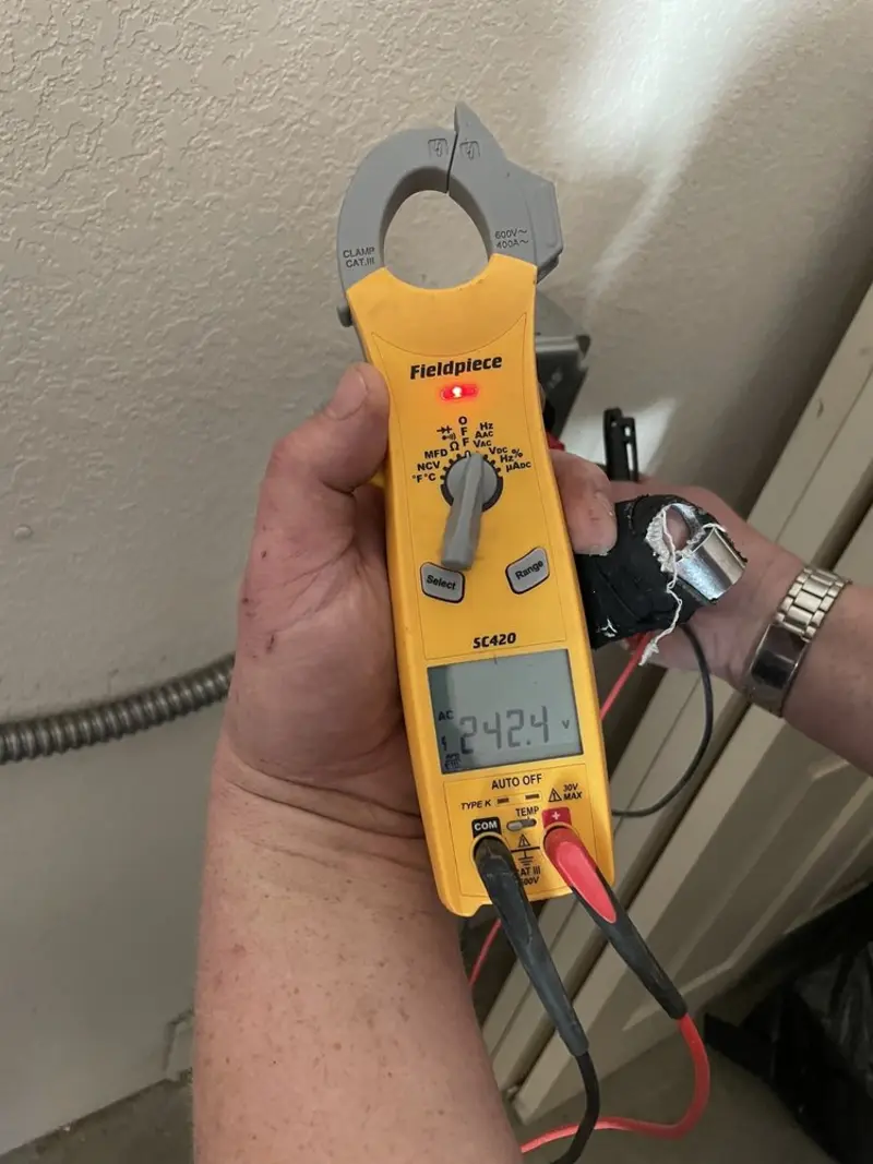 Voltage testing with clamp meter during Recessed Lighting Installation in Harlem